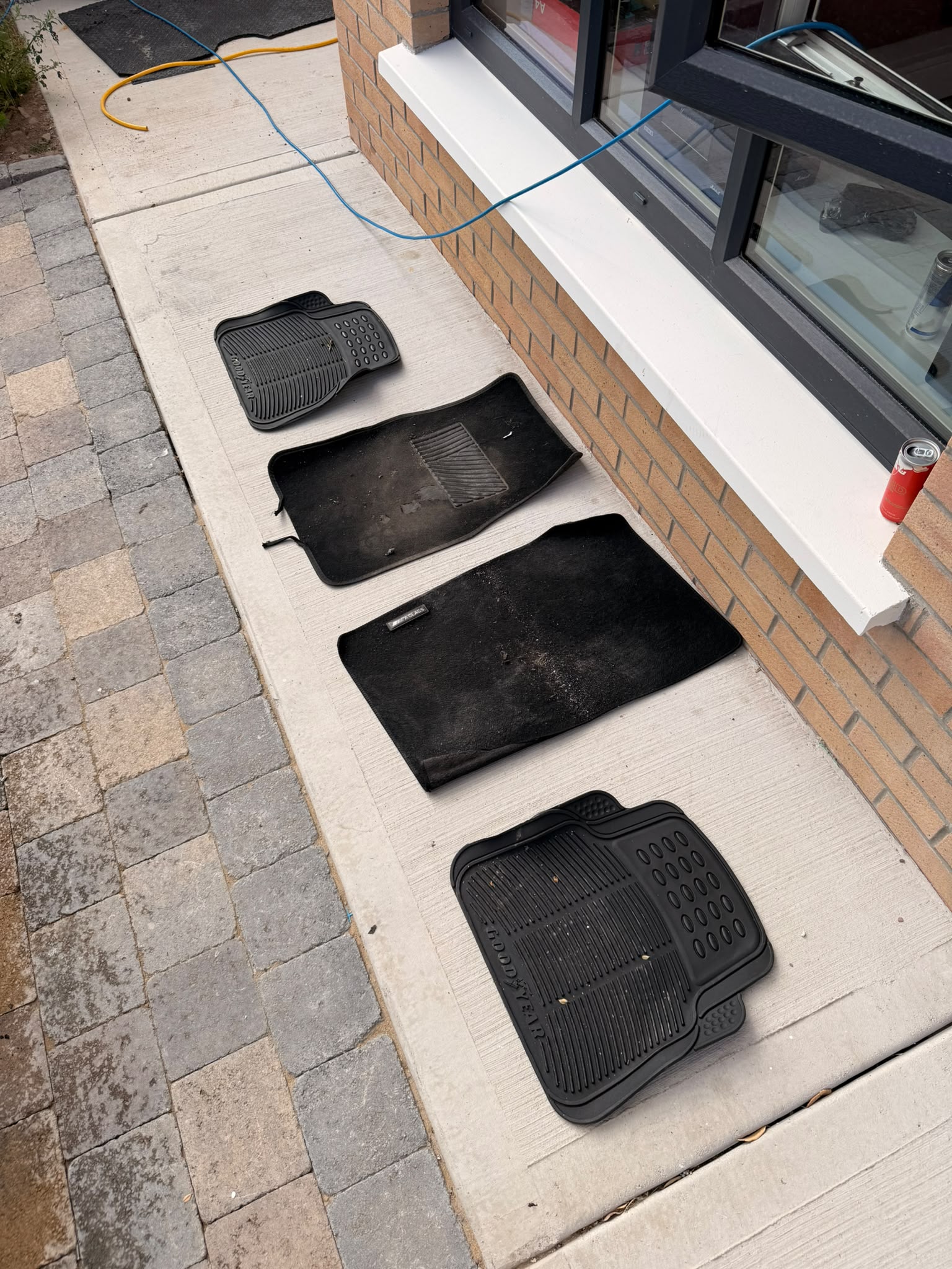 Freshly cleaned car mats drying outdoors